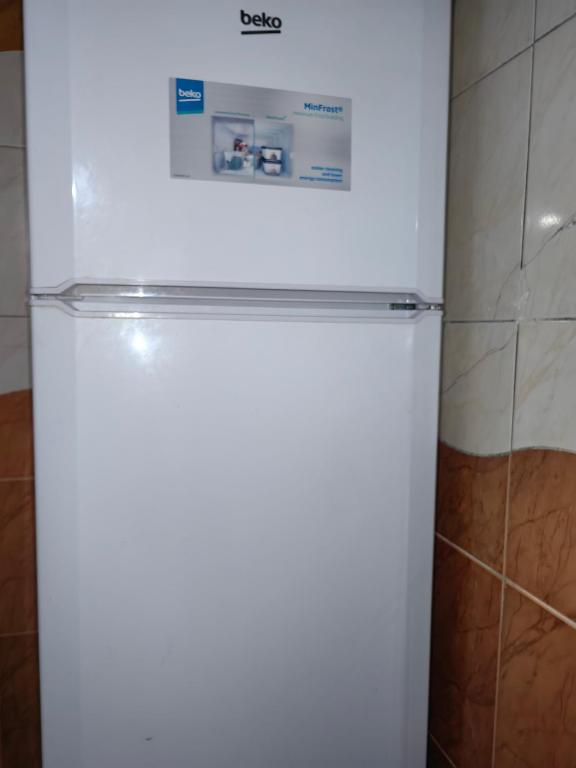 a white refrigerator with a sign on top of it at travel adventures 