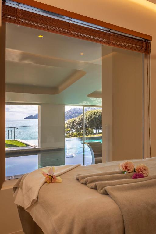 a bedroom with a bed with a large glass window at Hotel Continental in Santa Margherita Ligure