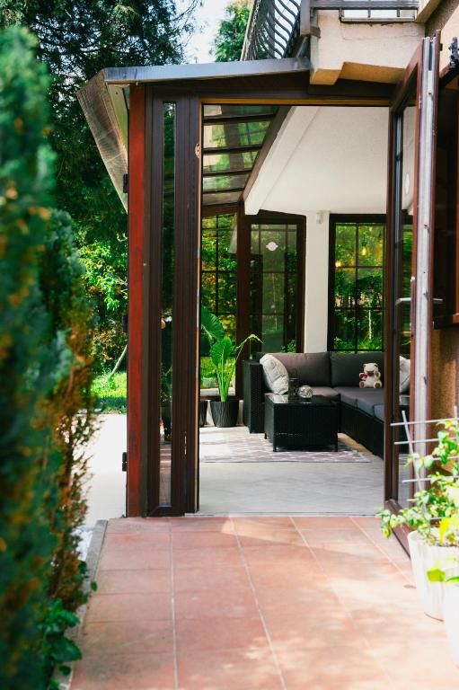 an open patio with a couch in a house at 6BDR Home in Nature in Sarajevo