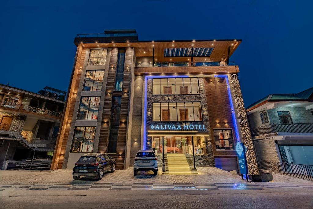 a building with a car parked in front of it at Alivaa Hotel, McLeodganj With Best Dhauladhar View & Infinity Pool Sky Garden in McLeod Ganj