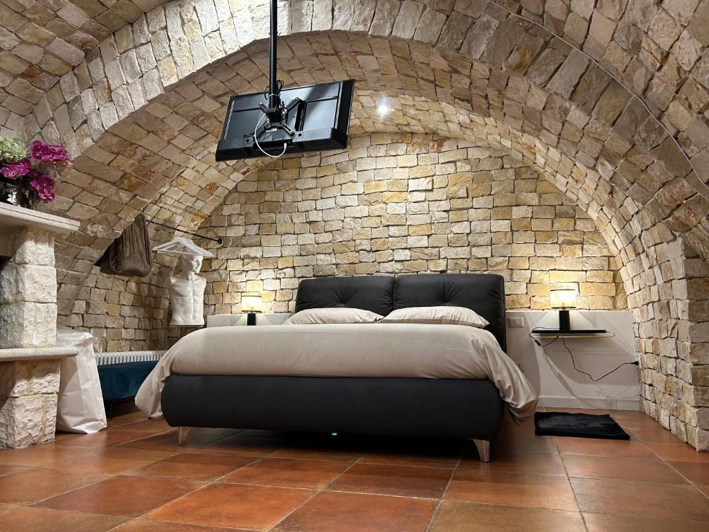 a bedroom with a bed in a brick wall at B&B Bari Vecchia R in Bari