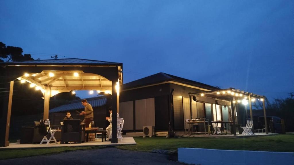 a man standing under a pergola at night at Shima City Detached house SKO1 in Katada