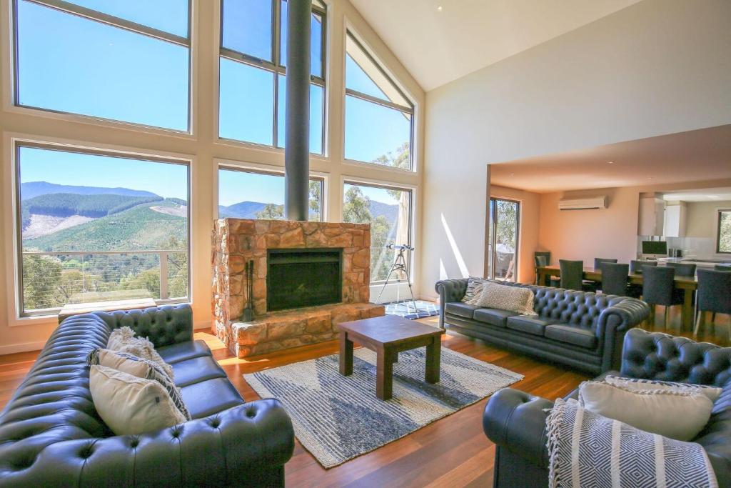 a living room with couches and a fireplace at Kangaroo Lodge in Bright