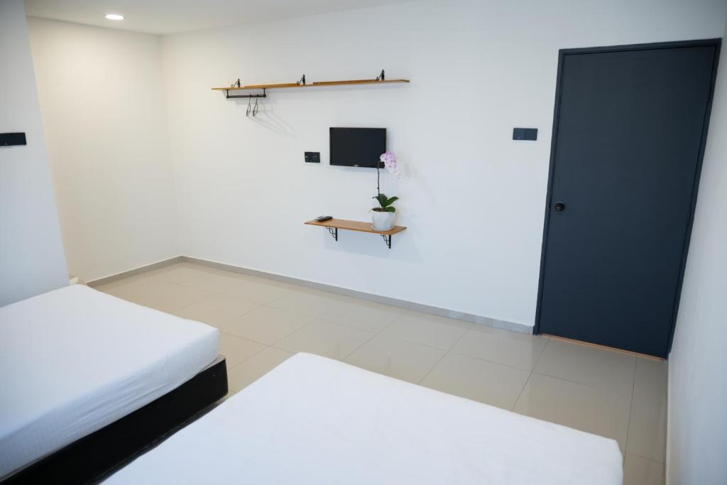 Postel nebo postele na pokoji v ubytování Orkid Inn Kajang