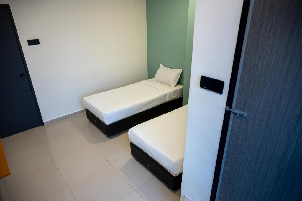 Postel nebo postele na pokoji v ubytování Orkid Inn Kajang