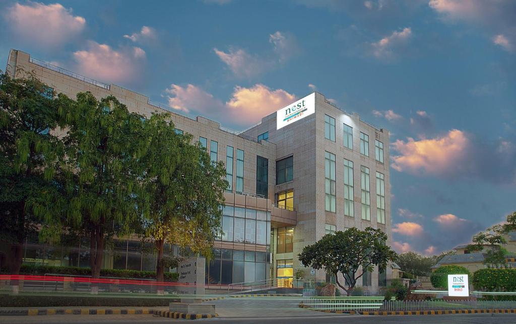 a building with a sign on the top of it at Nest By TreeHouse Bhiwadi in Bhiwadi