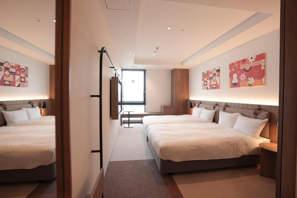 Postel nebo postele na pokoji v ubytování CINQS Hotel