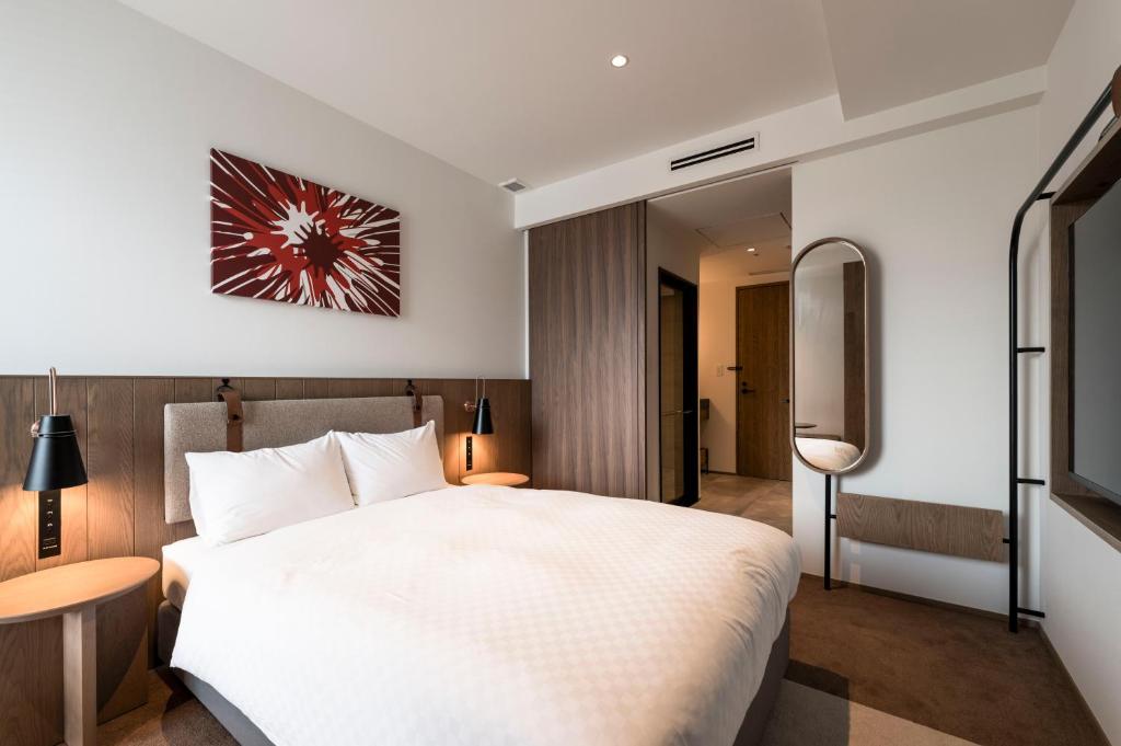 Postel nebo postele na pokoji v ubytování CINQS Hotel