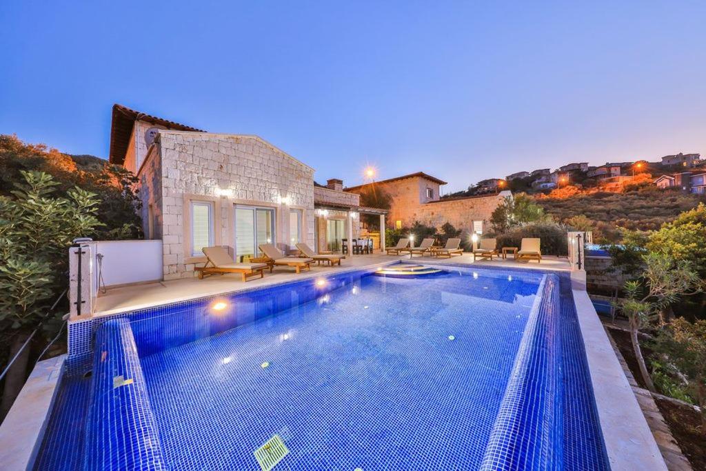a swimming pool in the middle of a house at Villa Basil in Kaş