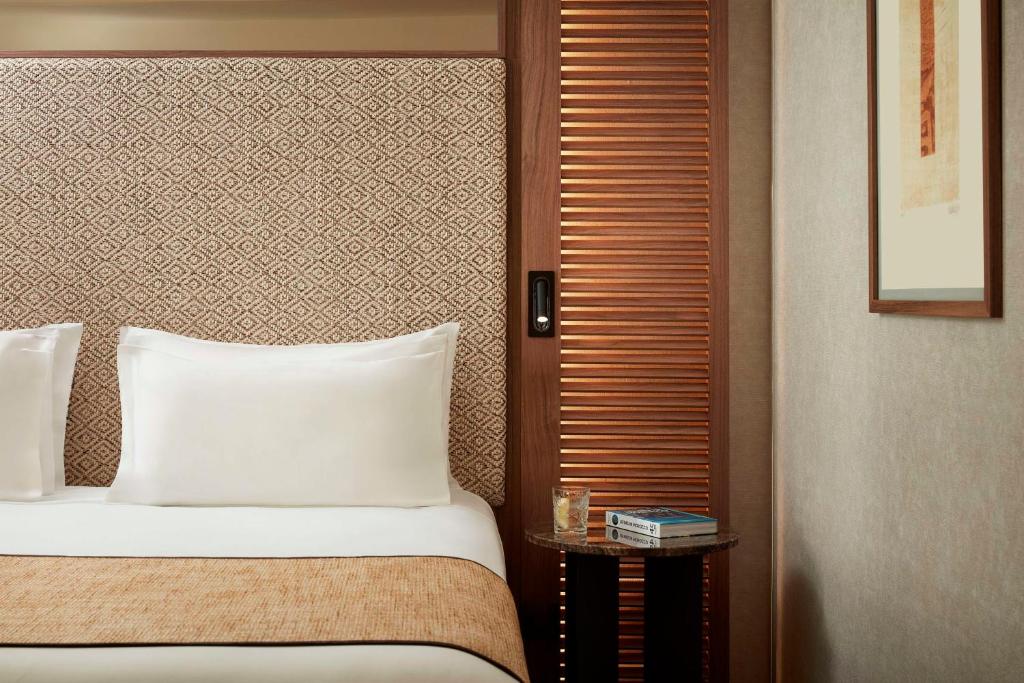 a hotel room with a bed and a side table at NH Collection Marbella in Marbella
