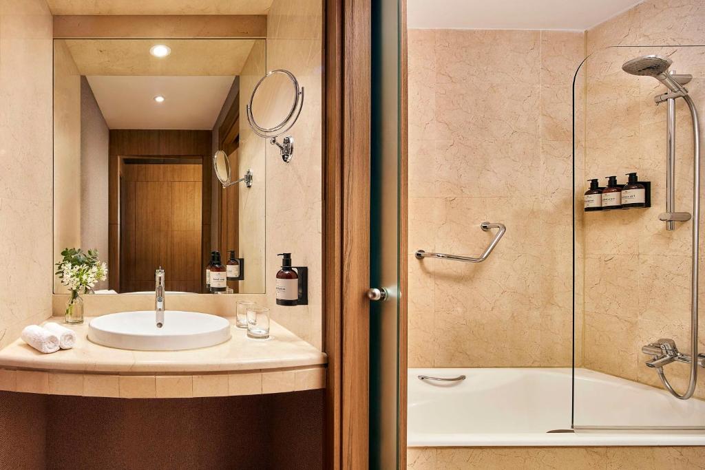 a bathroom with a sink and a shower at NH Collection Marbella in Marbella