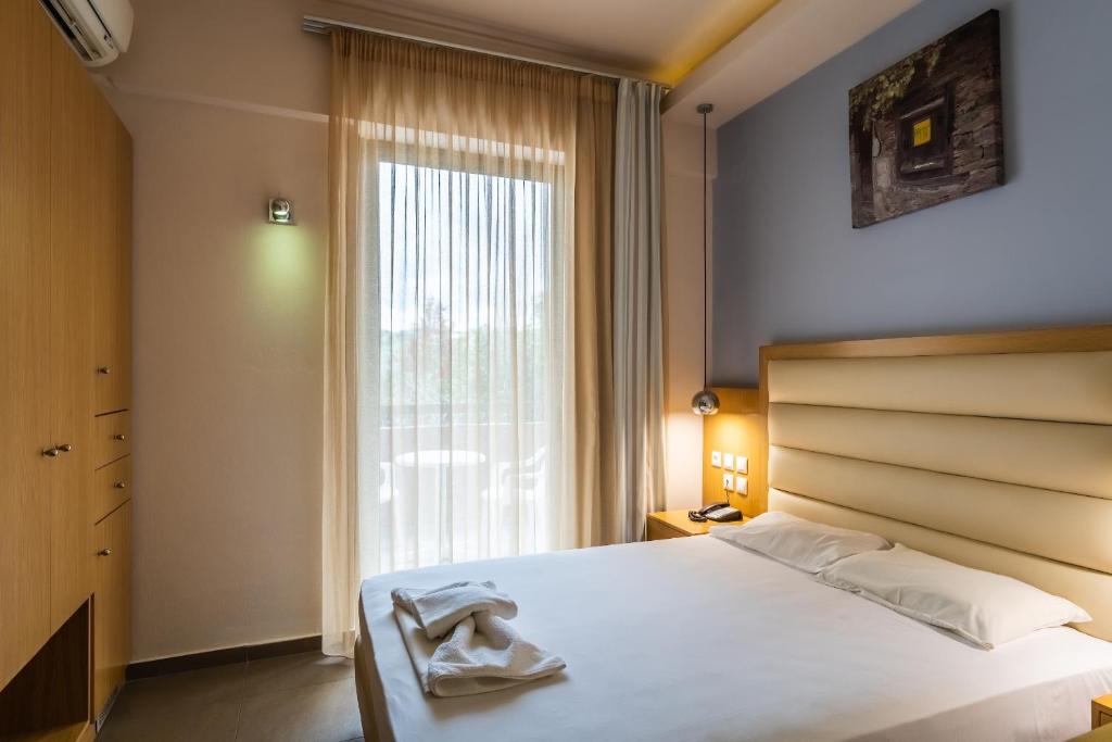 Postel nebo postele na pokoji v ubytování Pantheon Hotel