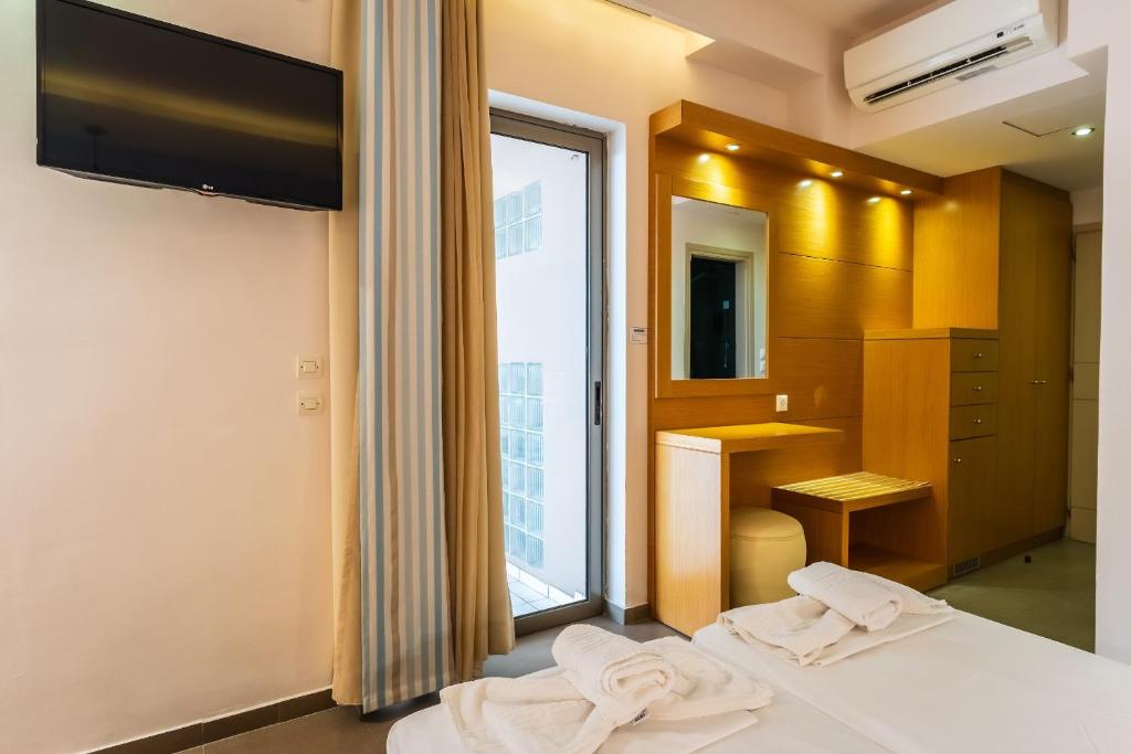Postel nebo postele na pokoji v ubytování Pantheon Hotel