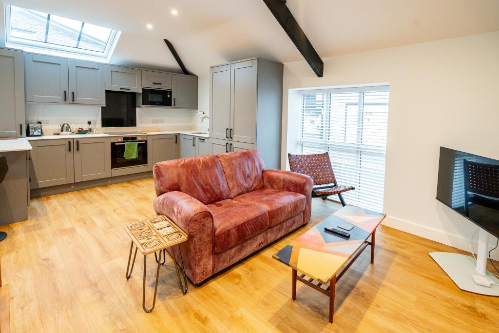 a living room with a couch and a kitchen at Town Center Duplex 6 in Harrogate