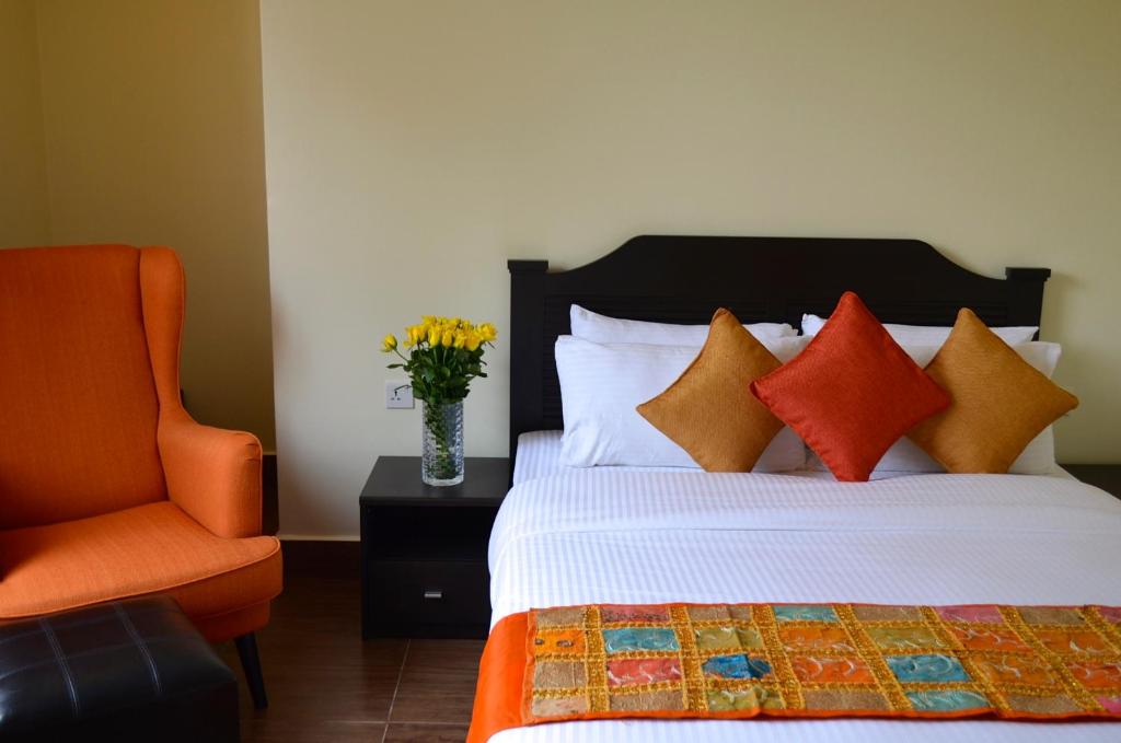 Postel nebo postele na pokoji v ubytování Gigiri Express Hotel