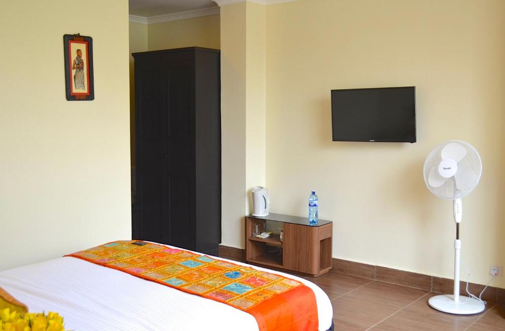 Postel nebo postele na pokoji v ubytování Gigiri Express Hotel