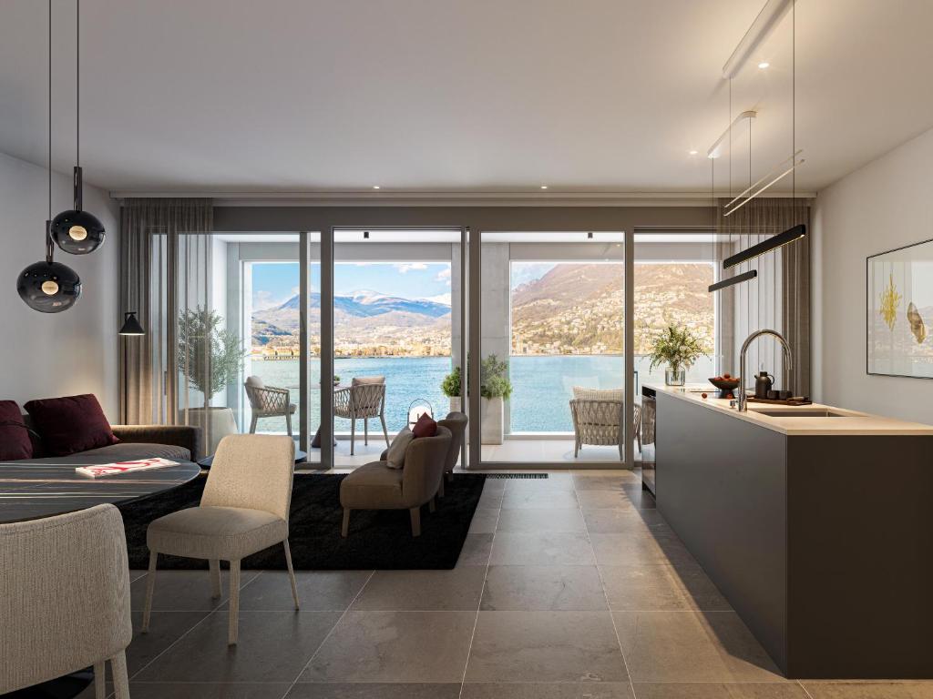 a kitchen and living room with a view of the water at Residenza Du Lac in Paradiso