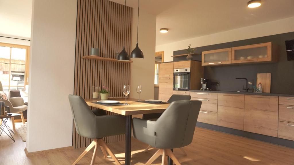 a kitchen and dining room with a wooden table and chairs at Ferienwohnung Reitemann in Oy-Mittelberg