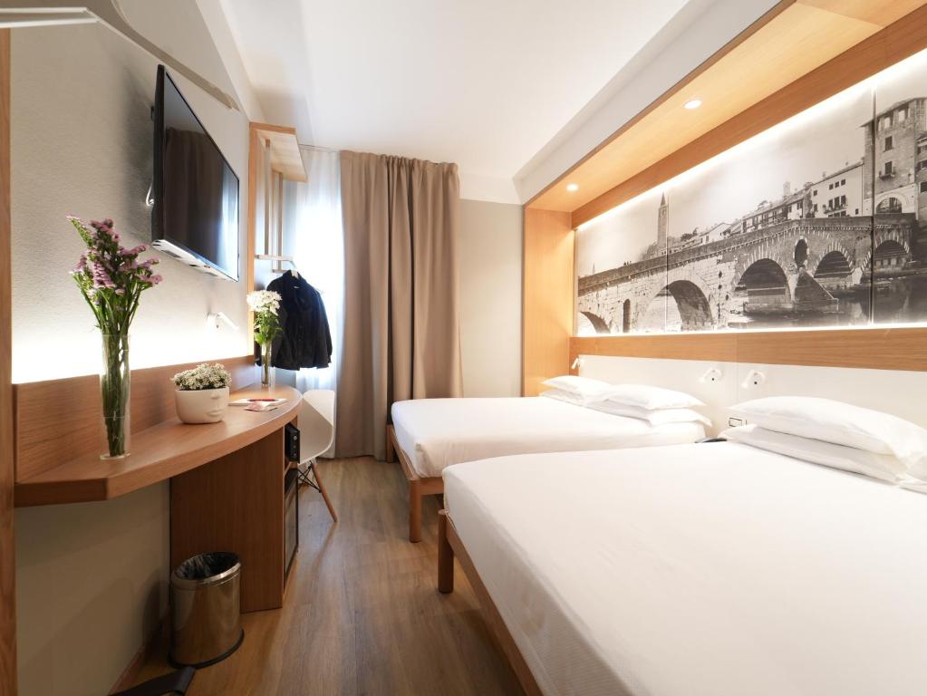 Postel nebo postele na pokoji v ubytování Cavallo Hotel Verona Est