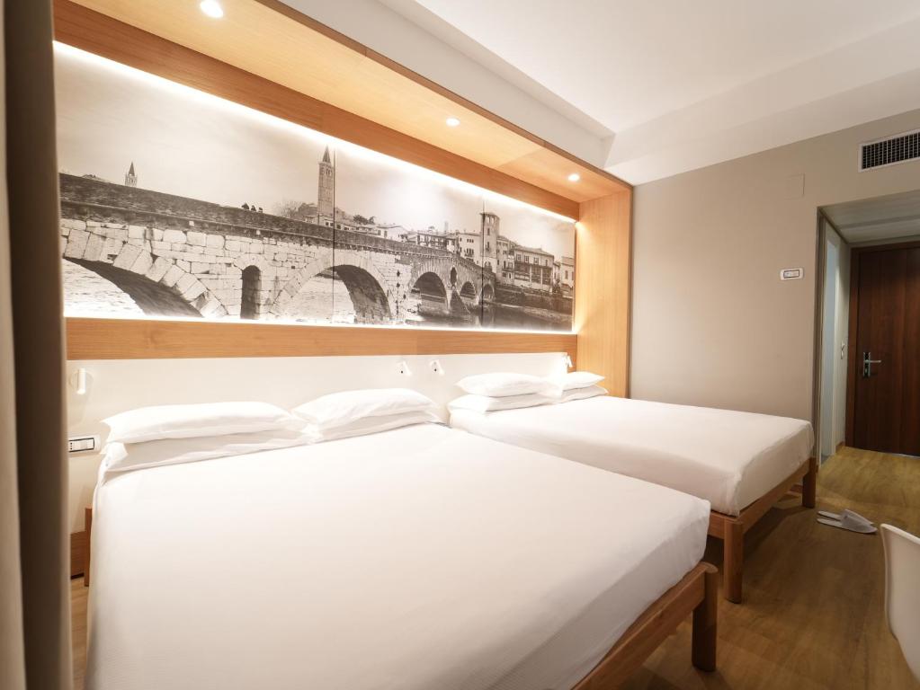 Postel nebo postele na pokoji v ubytování Cavallo Hotel Verona Est