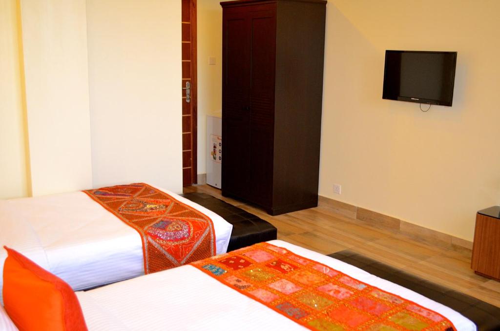 Postel nebo postele na pokoji v ubytování Gigiri Express Hotel