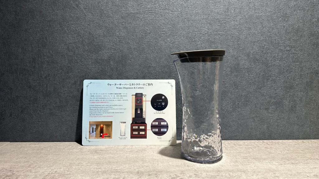 a glass vase sitting next to a box at Hotel Keihan Universal Tower in Osaka
