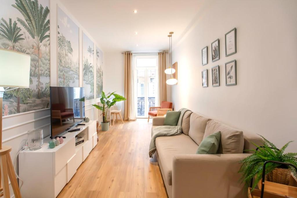 un salon avec un canapé et une télévision dans l'établissement #34 Lamartine Central 3 Bdrs AC balcony 10mins walk to old town, à Nice