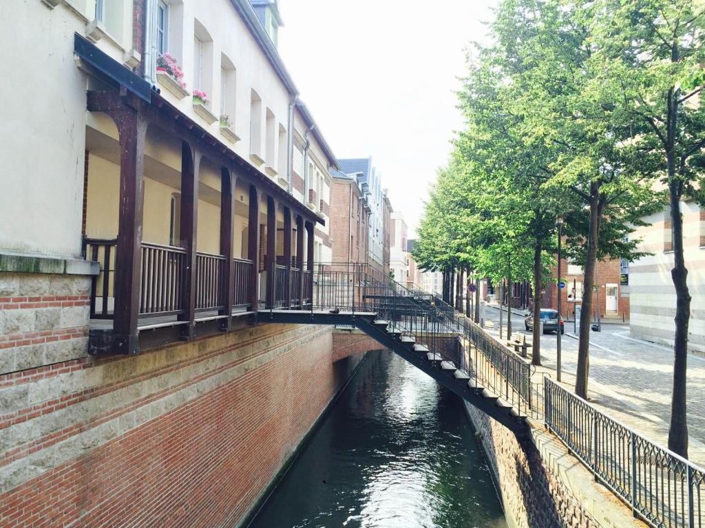 a bridge over a canal in a city at Hôtel De Normandie in Amiens