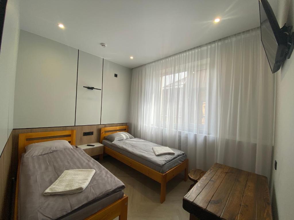 Postel nebo postele na pokoji v ubytování mini-hotel Neptun