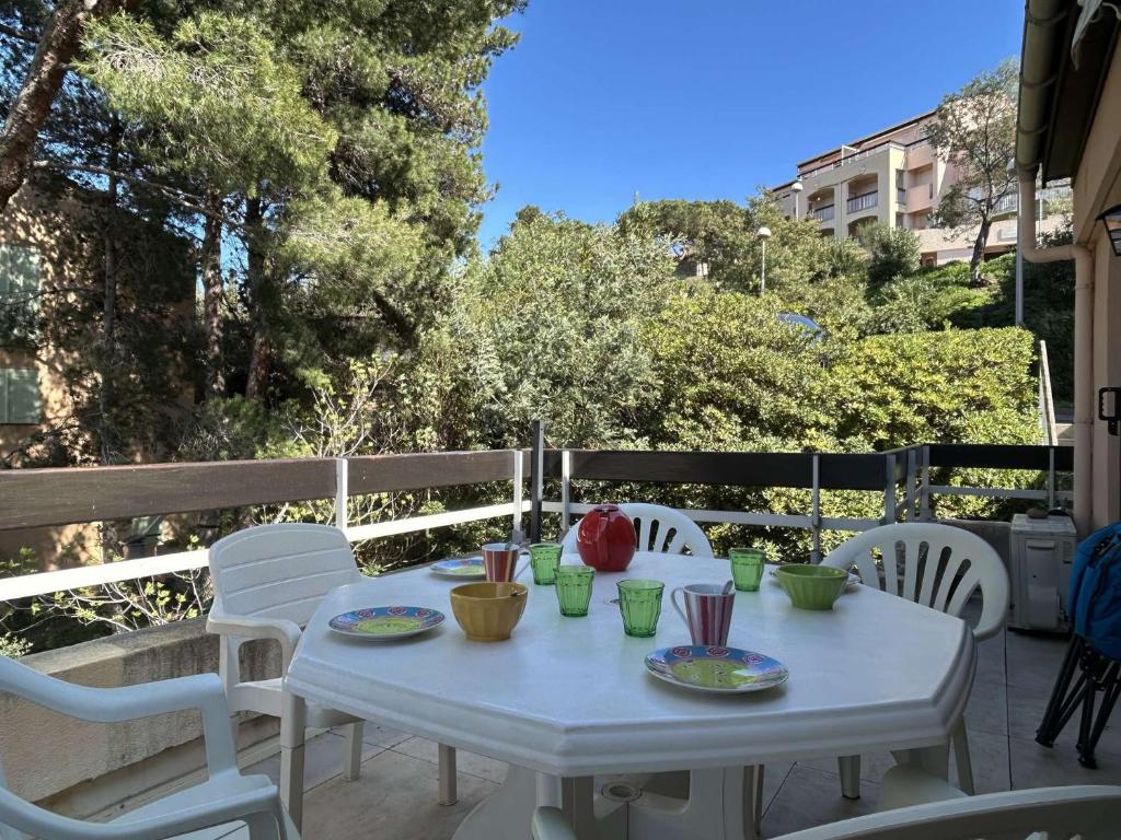 une table blanche et des chaises sur une terrasse dans l'établissement Appt T2 Mezzanine 4 couchages BANYULS SUR MER BN050-A05, à Banyuls-sur-Mer