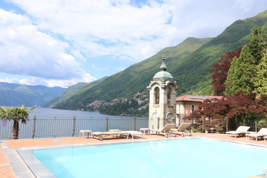 Pognana LarioにあるLake Como View - Luminosa casa con Parcheggio e PISCINAの建物と湖のあるスイミングプール