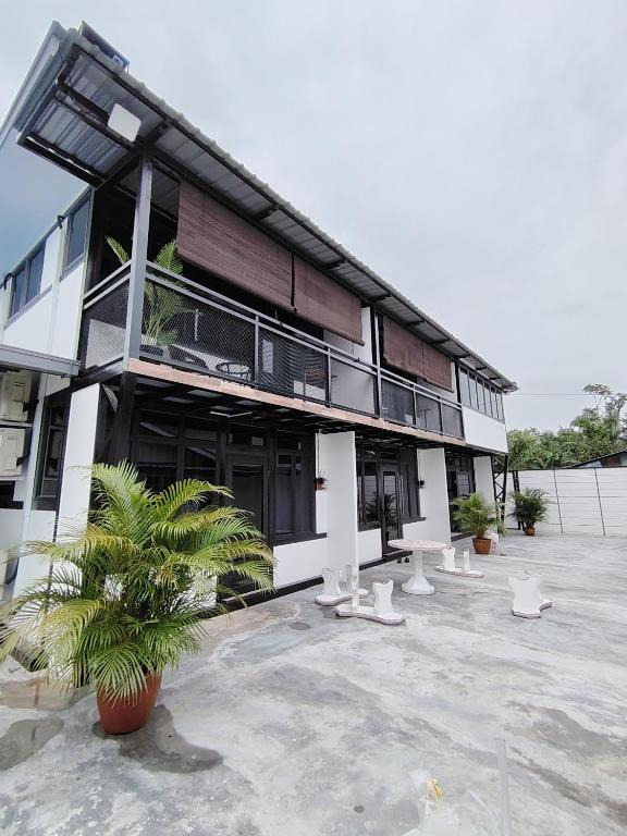 a building with a lot of plants in front of it at Homestay Daud in Bandar Permas