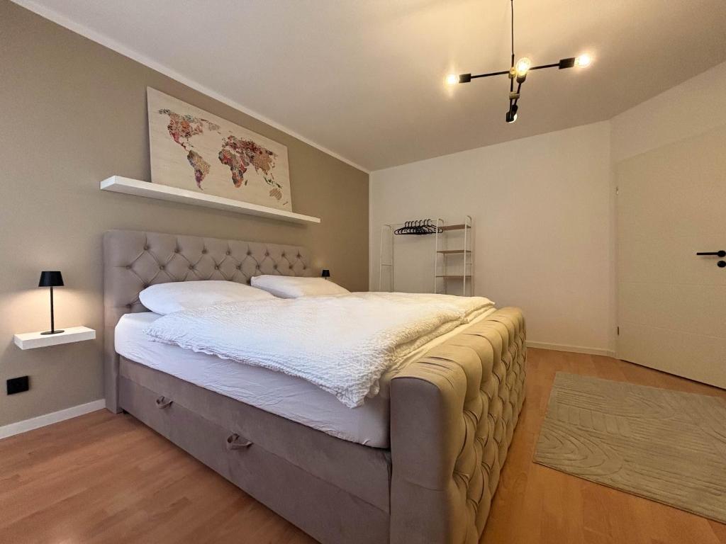 a bedroom with a large bed in a room at Ferienwohnung Naturkraft mit Tiefgaragenstellplatz und Balkon in Oberhof
