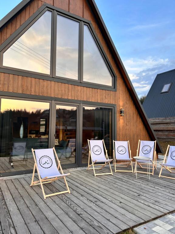 a group of lawn chairs sitting on a deck at Brdy Koniakowskie in Koniaków