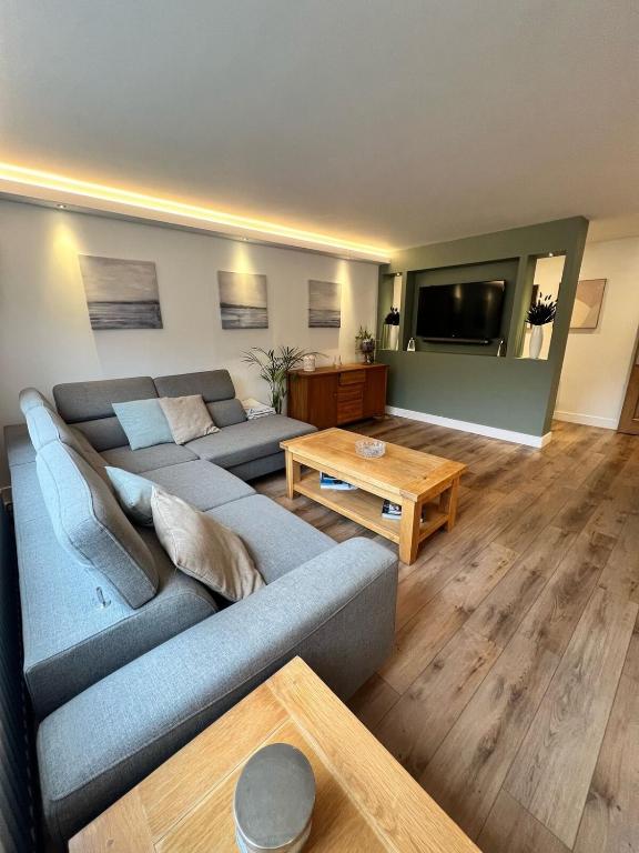 a living room with a couch and a table at Holiday Bungalow in Arnside in Arnside