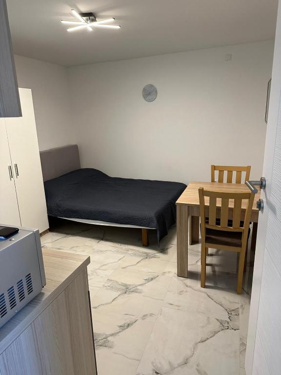 a small room with a bed and a table at Mimis Apartments in Novalja