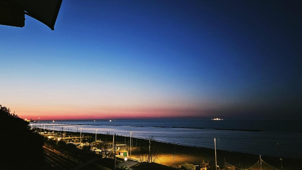 a view of a beach at night with the ocean at palombina vista mare in Ancona