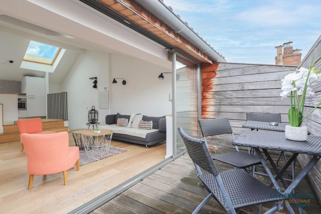 un patio avec une table, des chaises et un canapé dans l'établissement Dv7 Rooftop - Jean Jaurès - Métro Gare, à Toulouse