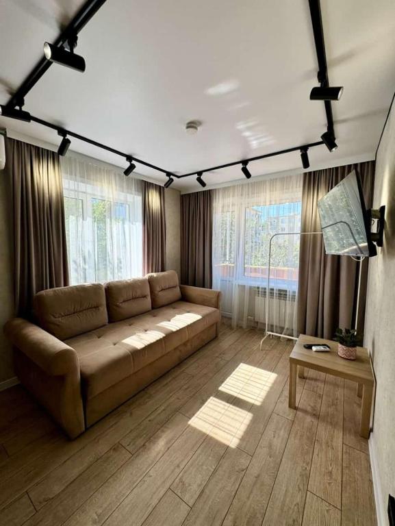 a living room with a couch and a table at Квартира 4-40 in Balqash
