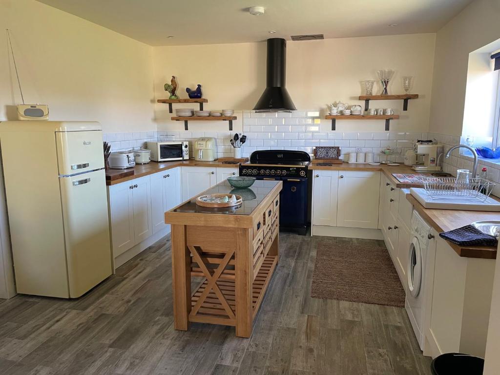 a kitchen with white cabinets and a stove top oven at Entire cosy home from home country retreat in Holyhead