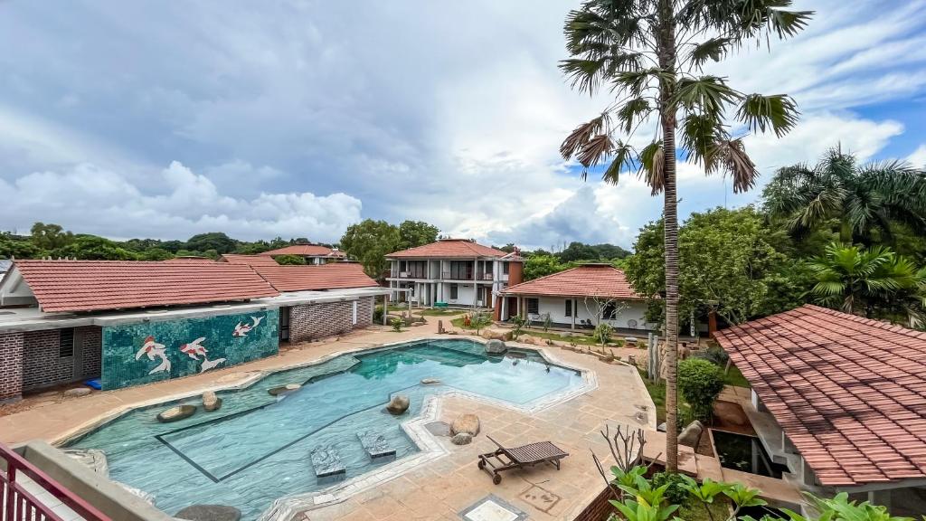 an overhead view of a swimming pool in a house with a palm tree at Temple Tree Retreat in Auroville