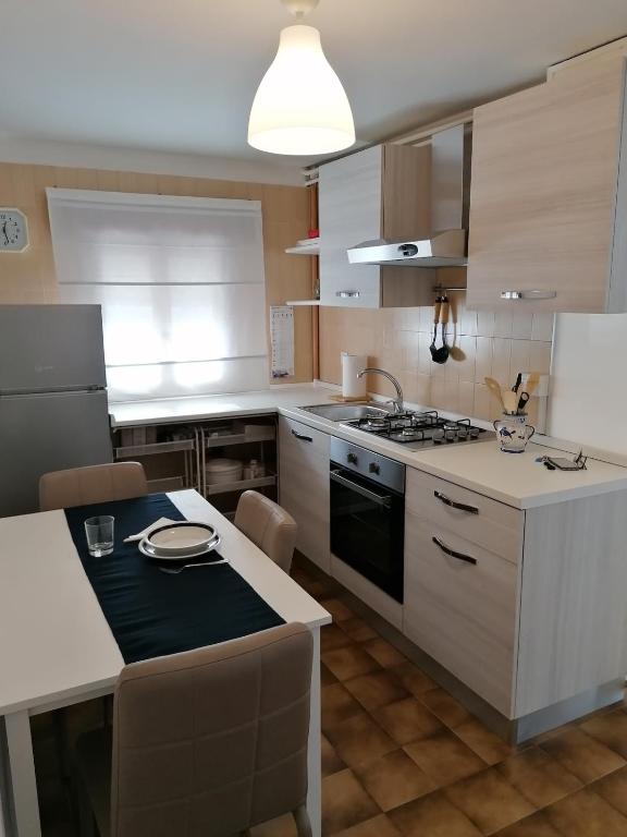 a kitchen with white cabinets and a stove top oven at Appartamento Zona ospedale in Treviso