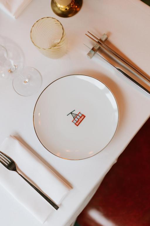 a white plate on a white table with chopsticks at Coeur de Megève in Megève