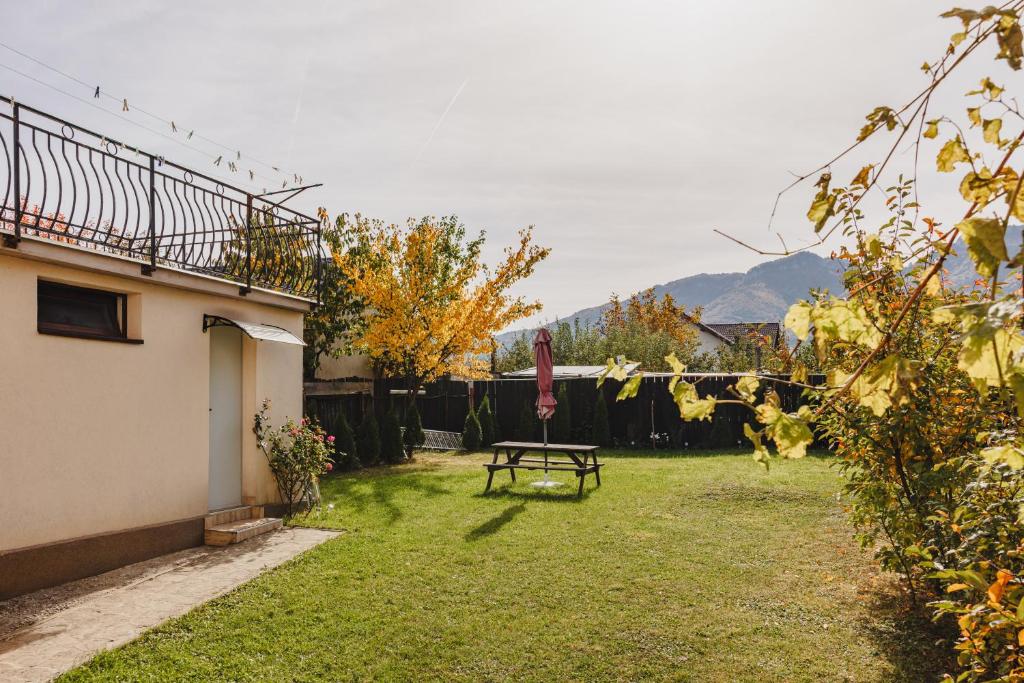 a backyard with a picnic table and a fence at View Bucegi-Adults Only in Zărneşti