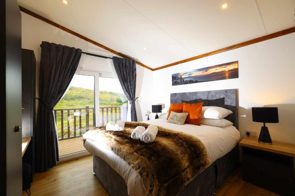 a bedroom with a large bed with towels on it at Applecross B&B and Luxury Self Catering Cabins free parking in Applecross