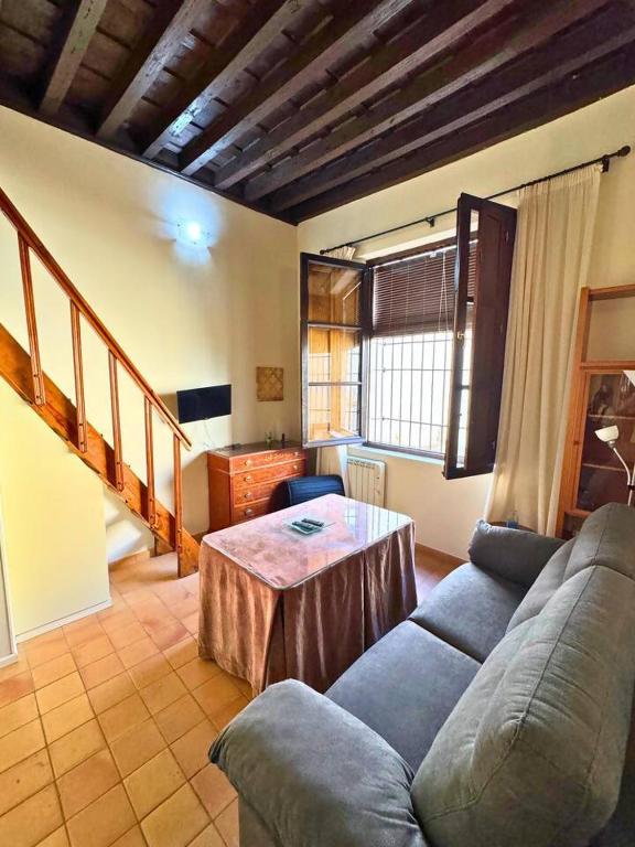 una sala de estar con un sofá y una mesa en Home4u Castillejos, en Granada