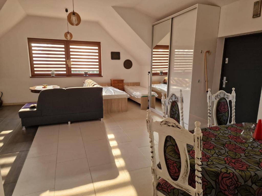 a living room with a couch and two beds at Duże mieszkanie w Kostkowie in Kostkowo