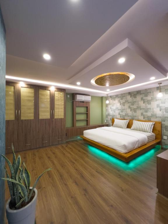 a bedroom with a bed with lights on the floor at Satori Apartment in Kathmandu