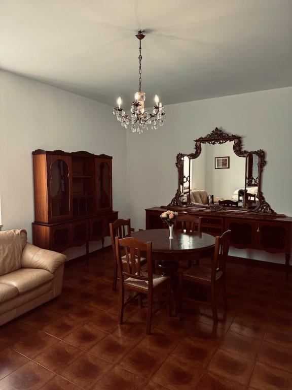 a dining room with a table and a mirror at Casa la Cascina in Pozzo Catena