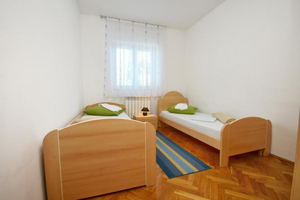 Łóżko lub łóżka w pokoju w obiekcie Apartments Rajic